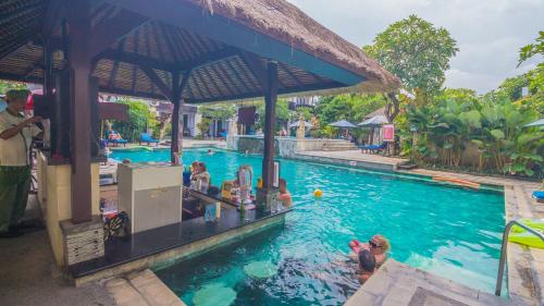 a group of people in a pool at a resort at The Lokha Legian Resort & Spa in Legian