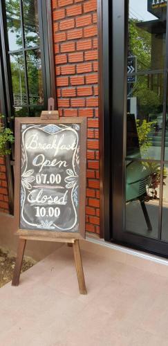 a sign in front of a door of a store at The Room Boutique Hotel in Sakon Nakhon