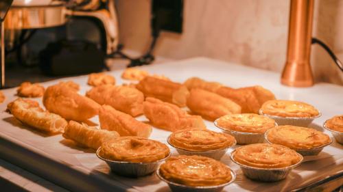 a bunch of pastries in muffin cups on a table at Paco Hotel Tiyuxilu Metro Guangzhou-Free Shuttle Bus during Canton Fair&5 Min walk to Canton Fair Buyer Registration Store in Guangzhou