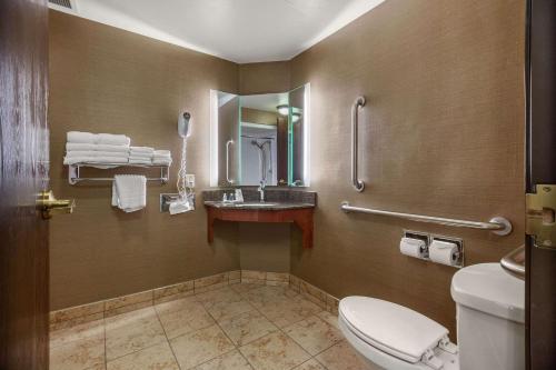 a bathroom with a toilet and a sink at Comfort Suites Green Bay West in Green Bay