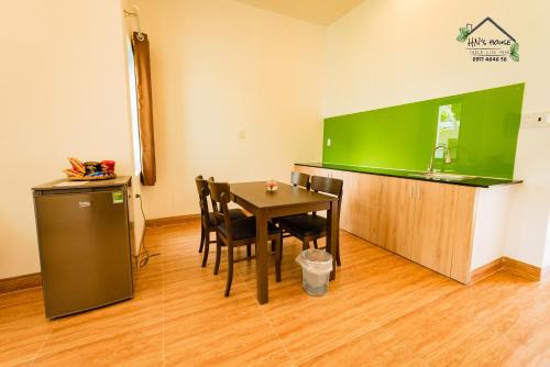a dining room with a table and a green counter at Hoàng Ngọc's House in Tuy Hoa