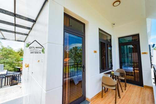 a home with a balcony with a table and chairs at Hoàng Ngọc's House in Tuy Hoa