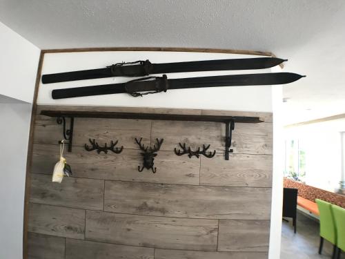 a knife rack with antlers on a wall at B&B Simmer in Obertraun