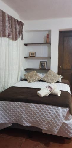 a bed with two pillows on it in a bedroom at Hotel Real Antigua in Antigua Guatemala