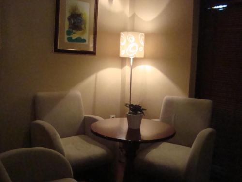 a room with a table and chairs and a lamp at Villa Dea in Ohrid