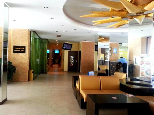 a lobby of a store with couches and a ceiling at Menada Royal Sun Apartments in Sunny Beach