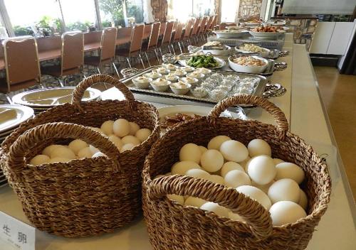two baskets of eggs on a table with food at Check In Matsuyama in Matsuyama