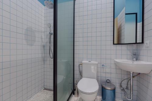 a bathroom with a shower and a toilet and a sink at Back2ME in Batumi