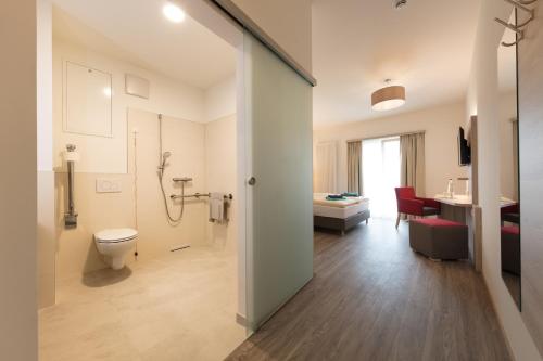 a bathroom with a toilet and a sink at Hotel Gudrun in Riedlingen