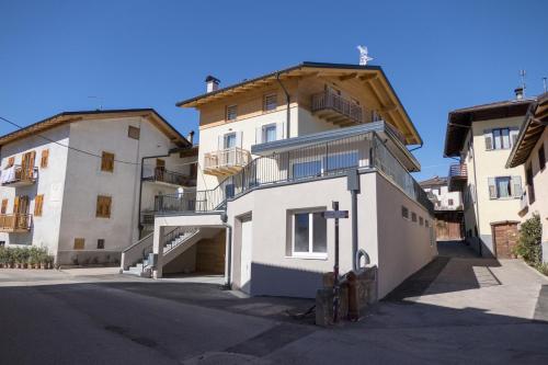 a large white building with a staircase in front of it at Agritur Piccolo Fiore B&B in Taio