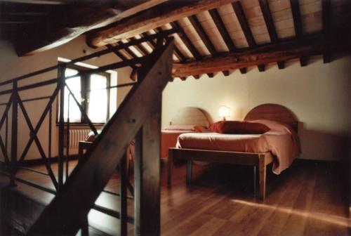 a bedroom with a large bed and a staircase at Il Casale in Treia