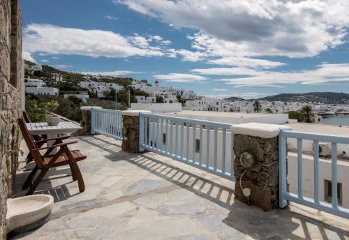 a balcony with a bench and a view of a city at Magic View Suites Mykonos in Mýkonos City