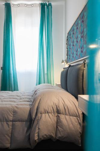 a bedroom with a bed with blue curtains at My Way - Suite - Rooms - Palazzo San Matteo in Palermo