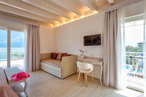 a bedroom with a bed and a desk in a room at Hotel Riviera Panoramic Green Resort in Limone sul Garda