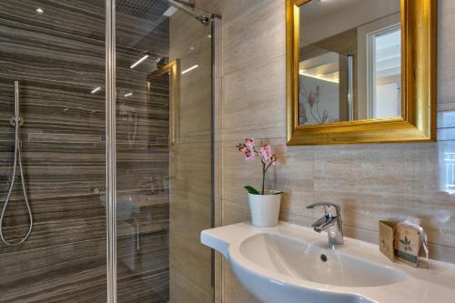 a bathroom with a sink and a shower at Hotel Riviera Panoramic Green Resort in Limone sul Garda