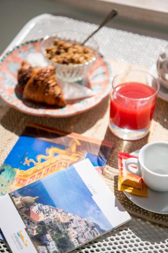 a table with a plate of food and a drink at Casa Guadagno in Positano