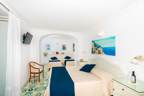 a white room with a bed and a table at Casa Guadagno in Positano