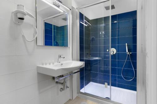 a bathroom with a sink and a shower at Eden Bleu in Vico Equense