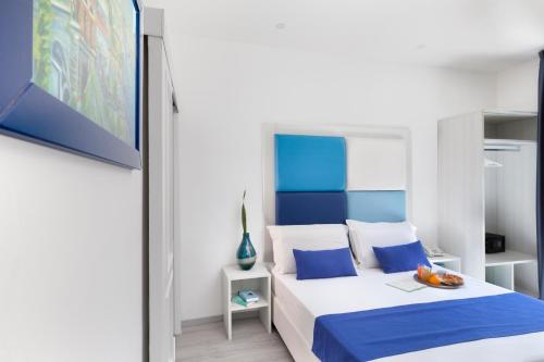 a bedroom with a bed with a blue headboard at Eden Bleu in Vico Equense