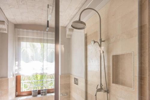 a shower stall in a bathroom with a window at Villa Galatea in San Vincenzo