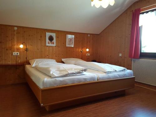 a bedroom with a large bed in a room at Haus Schwalbennest in Inzell