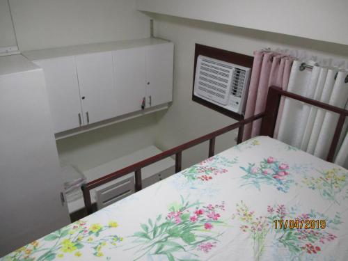 a bedroom with a bed with flowers on it at XNY at SMDC Trees Residences Quezon City-1 Bed RoomT2 in Manila