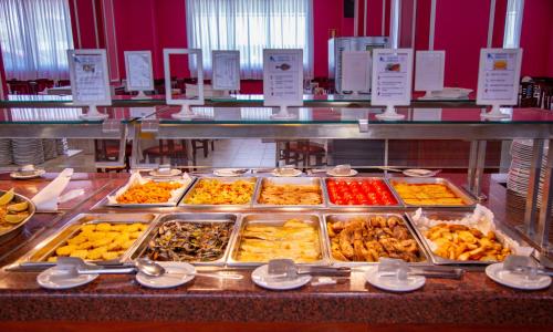 a buffet line with many different types of food at Gran Hotel Peñiscola in Peñíscola