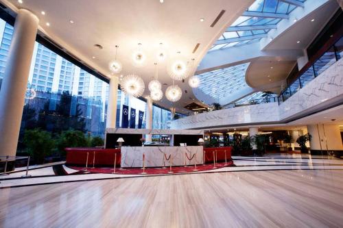a dance floor in a large building with chandeliers at Furama Hotel Dalian in Dalian