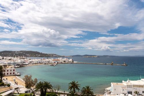 a view of a town with a pier in the water at Magic View Suites Mykonos in Mýkonos City