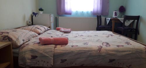 a bedroom with a bed with a blanket on it at Guesthouse Milka in Poljanak