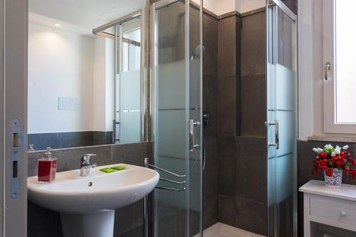 a bathroom with a sink and a glass shower at My Way - Suite - Rooms - Palazzo San Matteo in Palermo
