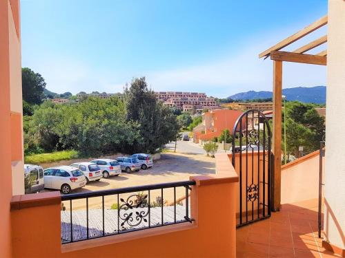 a balcony with a view of a parking lot at Sunny garden house in Villasimius