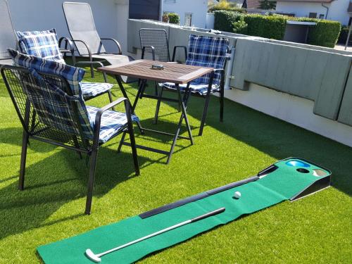 a fake baseball bat on the grass on a balcony at Ferienwohnung Sinsheim-Dühren in Sinsheim