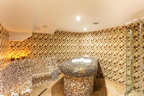 a bathroom with a shower and a toilet in a room at Family Hotel Romantika in Velingrad
