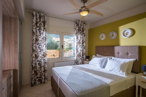 a bedroom with a large bed and a window at Sunshine Koutouloufari in Hersonissos
