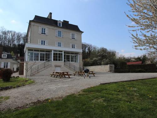 un edificio con dos mesas de picnic delante de él en Heritage Castle in Bar sur Seine, en Bar-sur-Seine