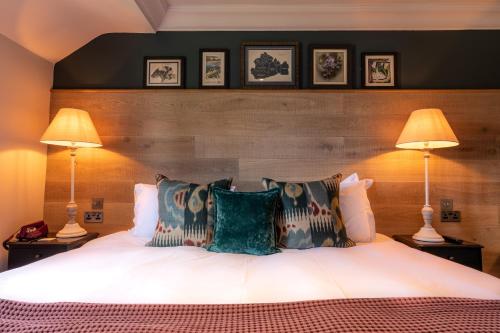 a bedroom with a large bed with two lamps at The Foley in Claygate