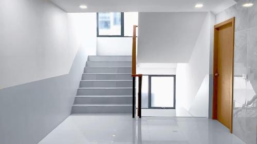 a staircase in a house with a door and a stair case at Phoenix Hotel Karon Beach in Karon Beach