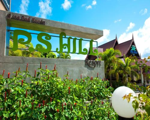 a sign in front of a building with plants at PS Hill Resort Phuket Patong - SHA Plus in Patong Beach