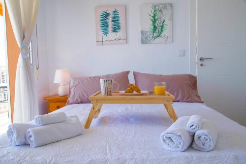 a room with a bed with a table with towels at Luxury 12th Floor Beachfront in El Campello