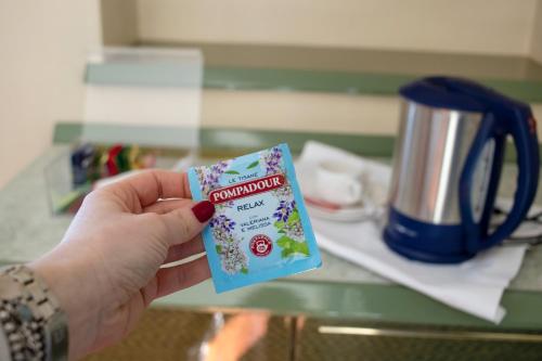 a person holding up a package of gum in a hand at Hotel Royal in Fermo