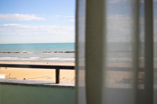 a view of the beach from a window at Hotel Royal in Fermo