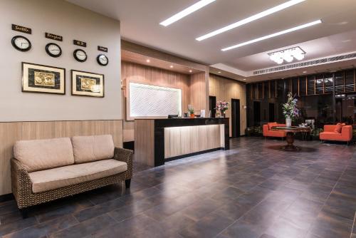 a waiting room with a chair and a podium at Marsi Hotel Bangkok in Bangkok