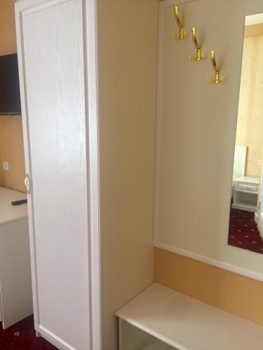 a small room with a white cabinet and a table at Sergeev Hotel in Mykolaiv