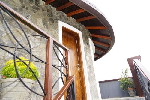an entrance to a stone building with a wooden door at The Ramp in Nuwara Eliya