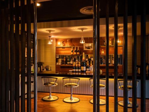 a bar with three bar stools in a room at Nagominoyado Hanagokoro - Reopening in Mar 2024 in Hakone