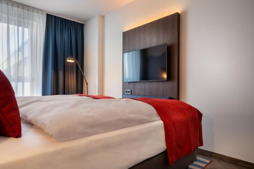 Ένα ή περισσότερα κρεβάτια σε δωμάτιο στο Holiday Inn - the niu, Keg Hamburg Ost by IHG