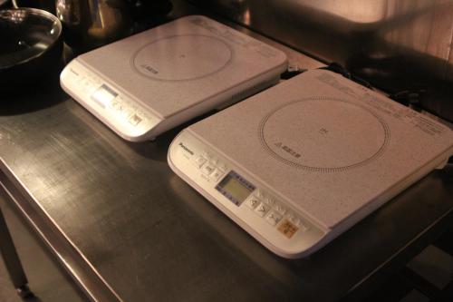 two electronic devices sitting on top of a table at Shaq Bighouse in Kanazawa