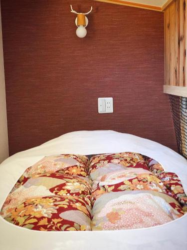 a bed with two pillows on top of it at Stay Nikko Guesthouse in Nikko