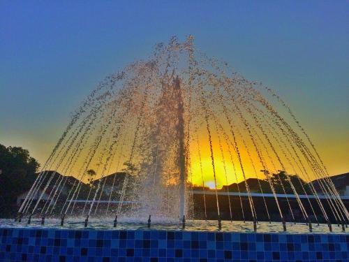 a fountain with water spraying into the air at Southern Airport Hotel Hatyai in Hat Yai